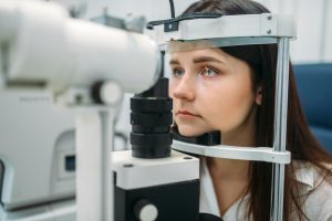 Accent Eye Care female-patient-on-eyesight-test-optician-cabinet-N25UXR8  